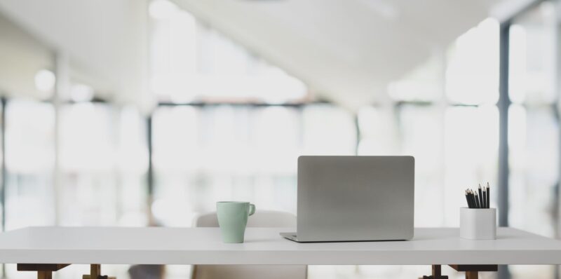 silver laptop in white wooden table